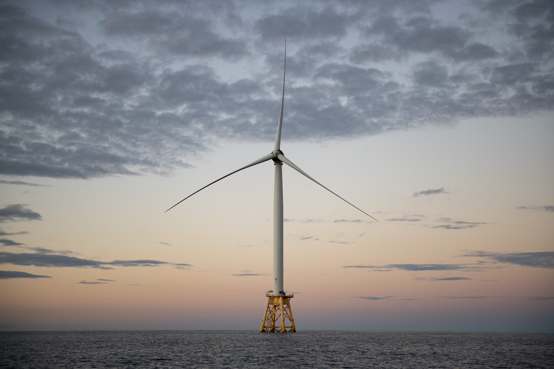 Wind turbine during sunset. Block Island Wind Farm is the first commercial offshore wind farm in the United States, located 3.8 miles (6.1 km) from Block Island, Rhode Island in the Atlantic Ocean. The five-turbine, 30 MW project was developed by Deepwater Wind. Construction began in 2015 and in late summer 2016 five Alstom Haliade 150-6-MW turbines were erected. Operations were launched in December 2016. It is the largest project using wind power in Rhode Island, USA.