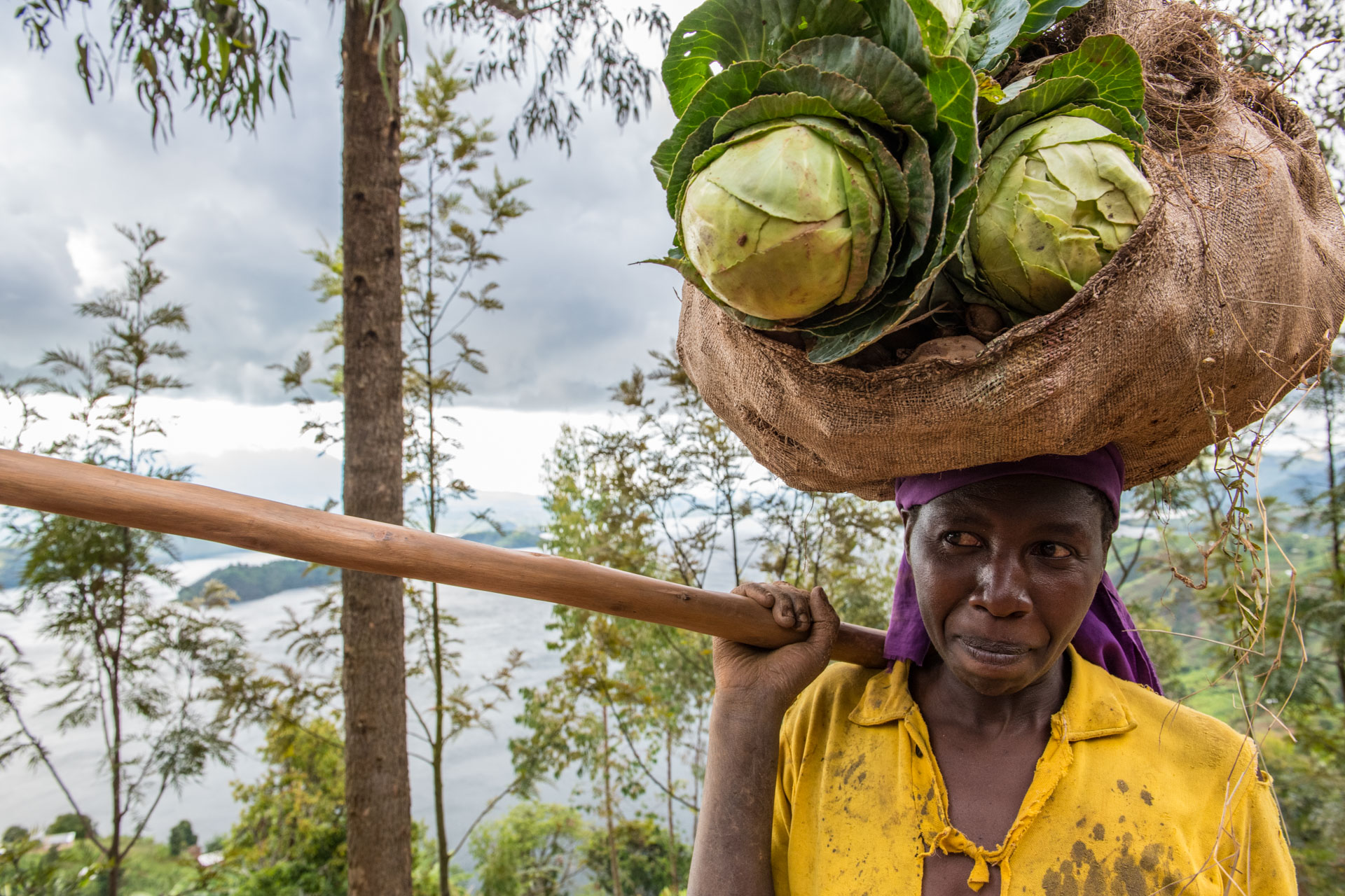 Local community member near Burera District, Cyanika Sector, with vegetables. Rwanda, Africa.